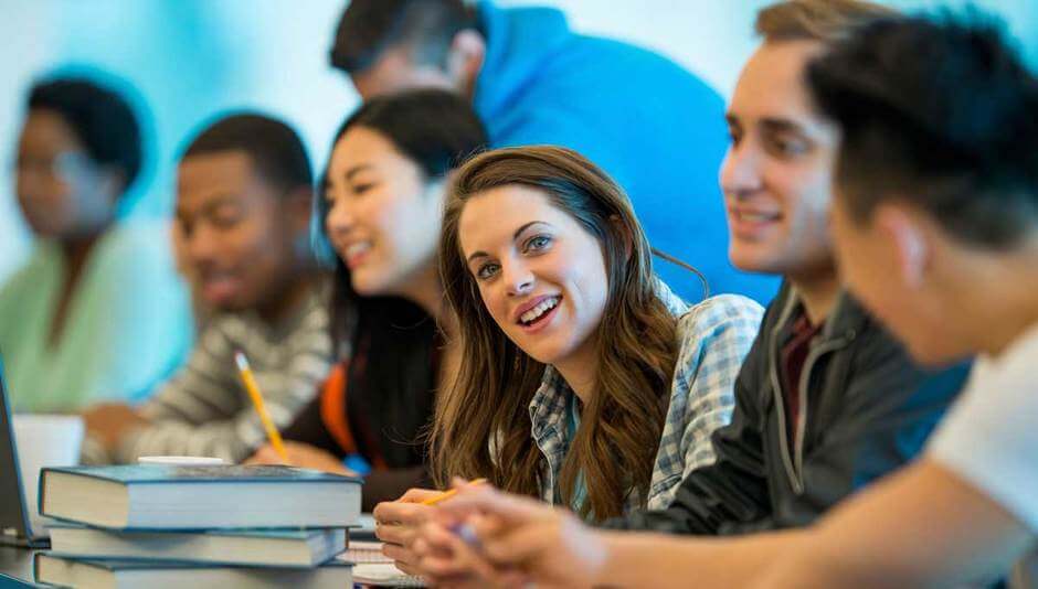college students studying together in classroom