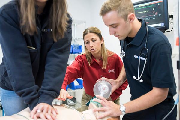 adult students training with CPR manikin adult students training with CPR manikin