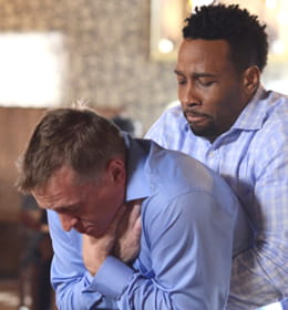 Heartsaver First Aid CPR AED man assisting a choking gentleman image